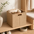 Handwoven woven storage bin used for pet essentials in an entryway